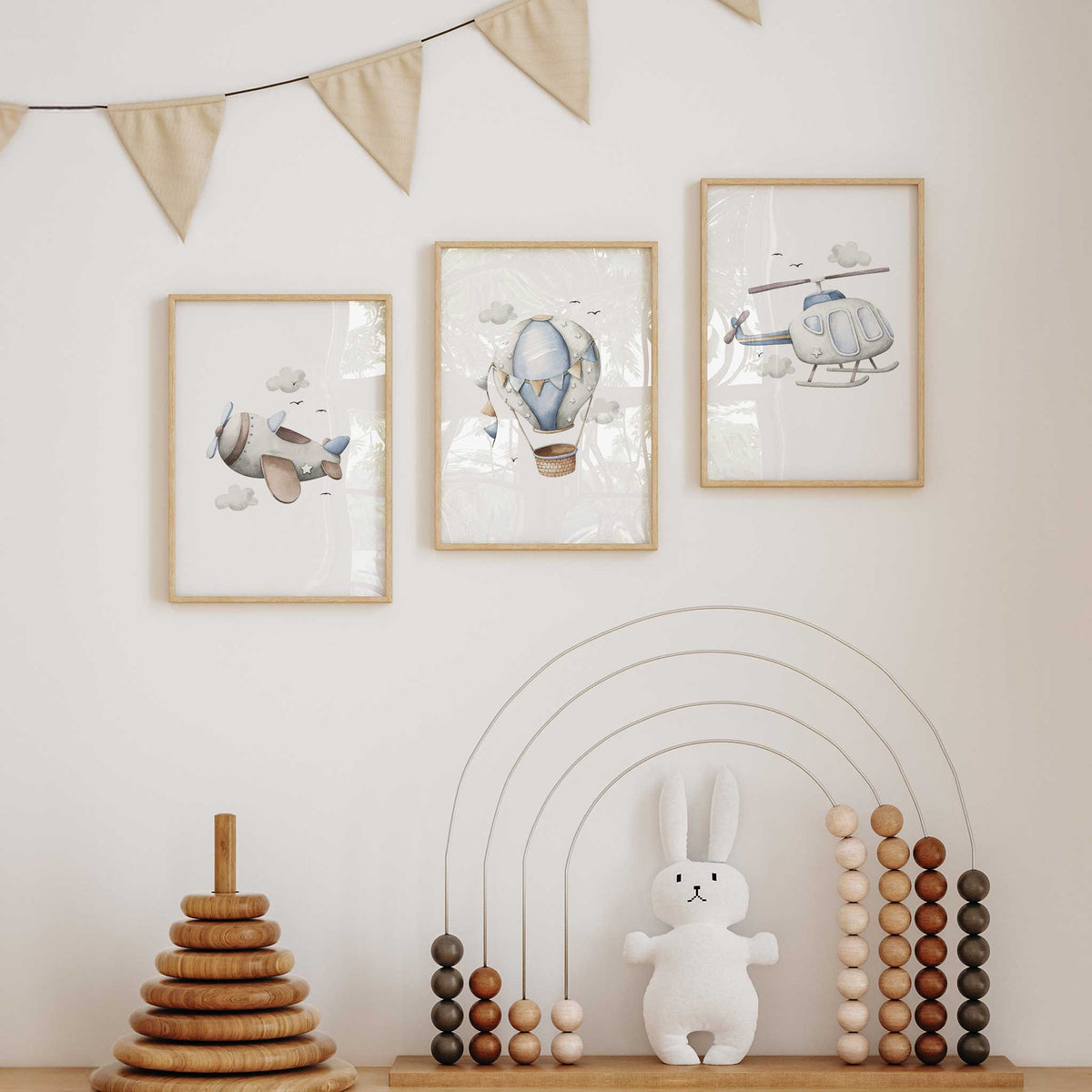 Three blue nursery prints showing an aeroplane, hot air balloon and helicopter with coordinating cloud details