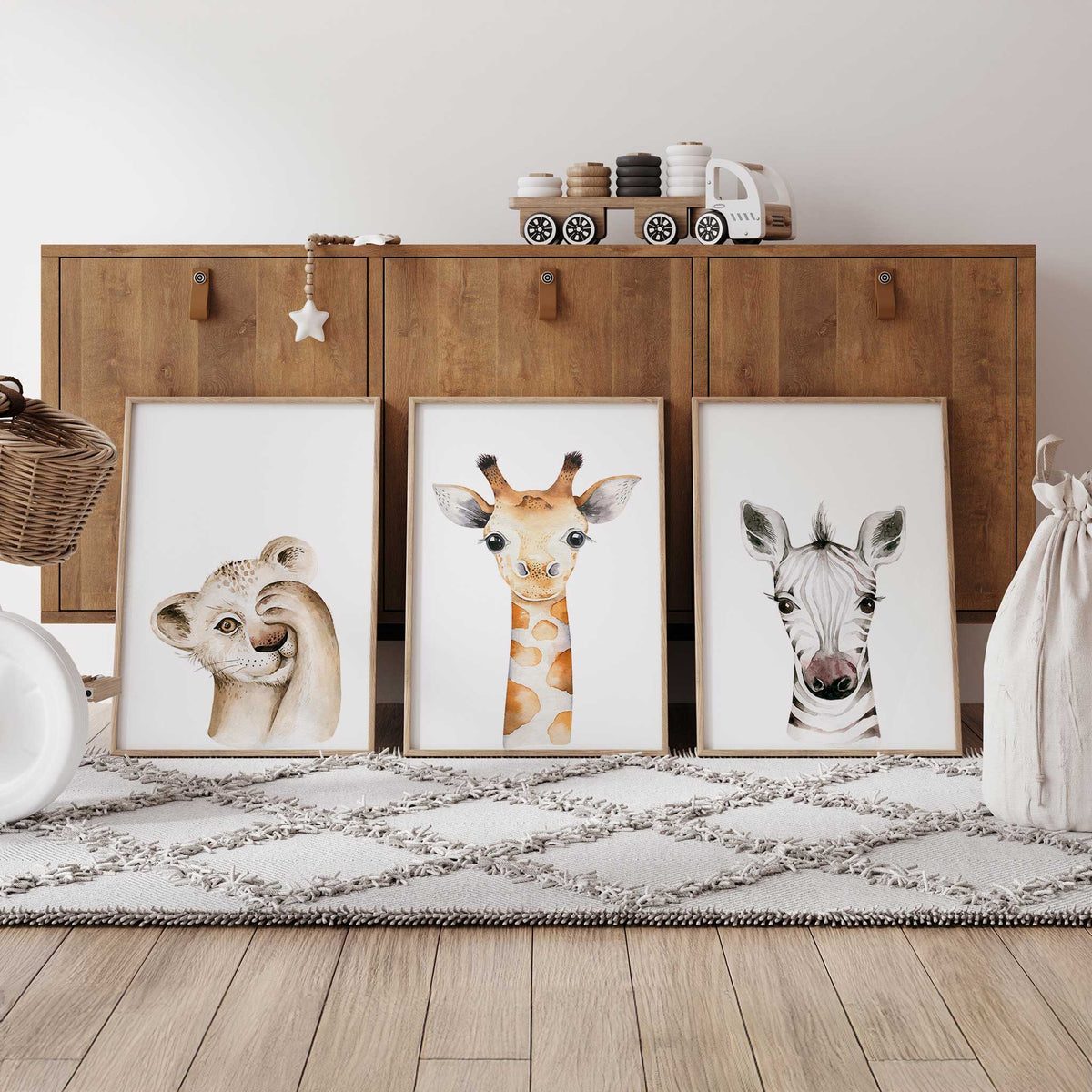 Set of three baby safari nursery prints featuring a lion cub, giraffe and zebra in soft watercolour on white backgrounds.
