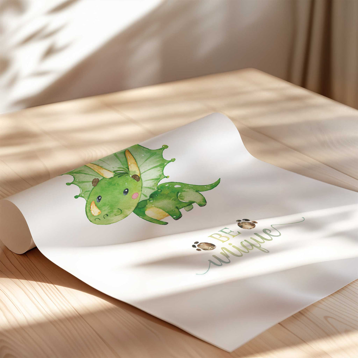 Green triceratops with pink cheeks above Be unique lettering and small footprint details on a white art print.