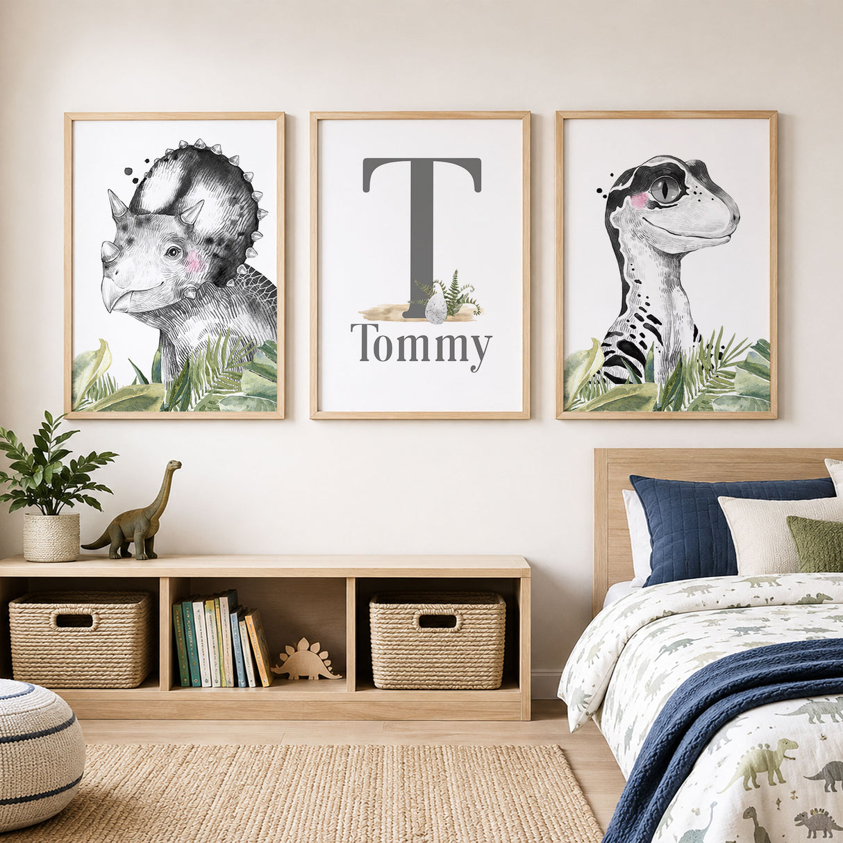 Personalised dinosaur wall art set with name and initial, black and white portraits and green leaves