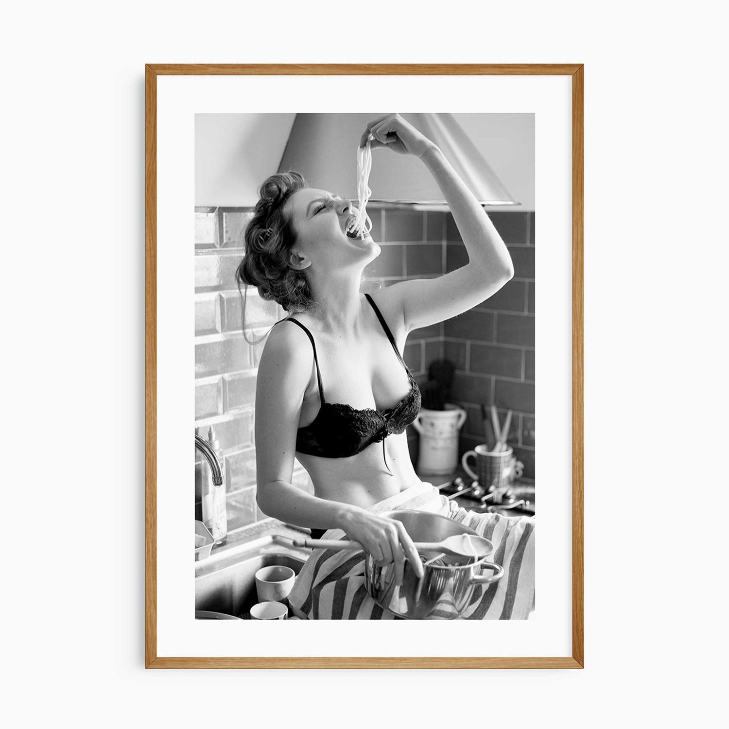 Black and white kitchen wall art featuring a glamorous woman eating spaghetti from the pot.