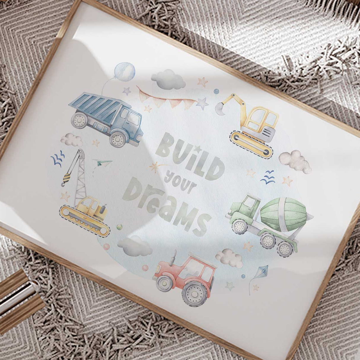 Construction vehicle print for a boys bedroom featuring soft blue yellow green and red trucks with Build Your Dreams text
