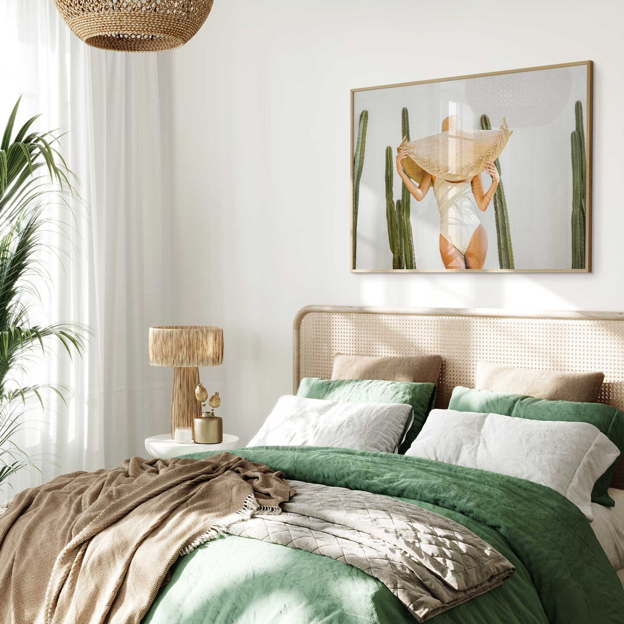 Cactus photography wall art showing a woman in an ivory swimsuit and straw hat.