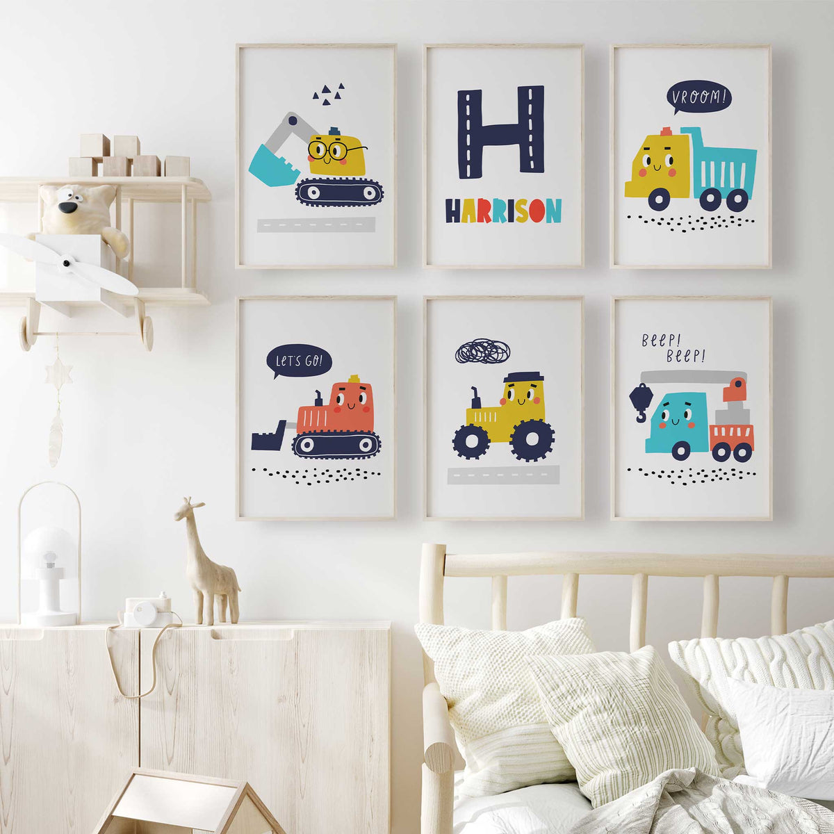 Cartoon construction prints set of six with a navy road initial, multicoloured name and five smiling vehicle designs.
