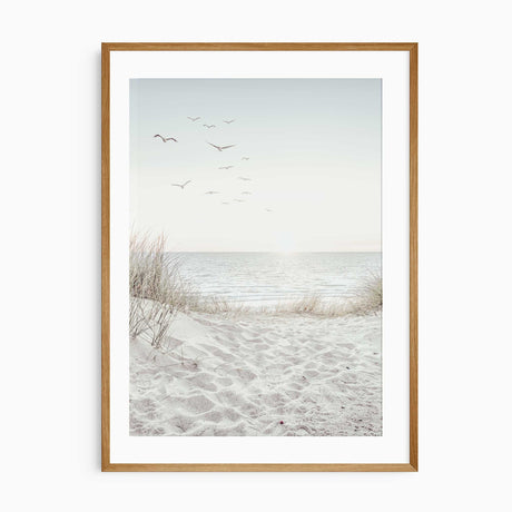 Coastal wall art print with sandy dunes and ocean view under a soft sky.