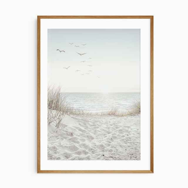 Coastal wall art print with sandy dunes and ocean view under a soft sky.