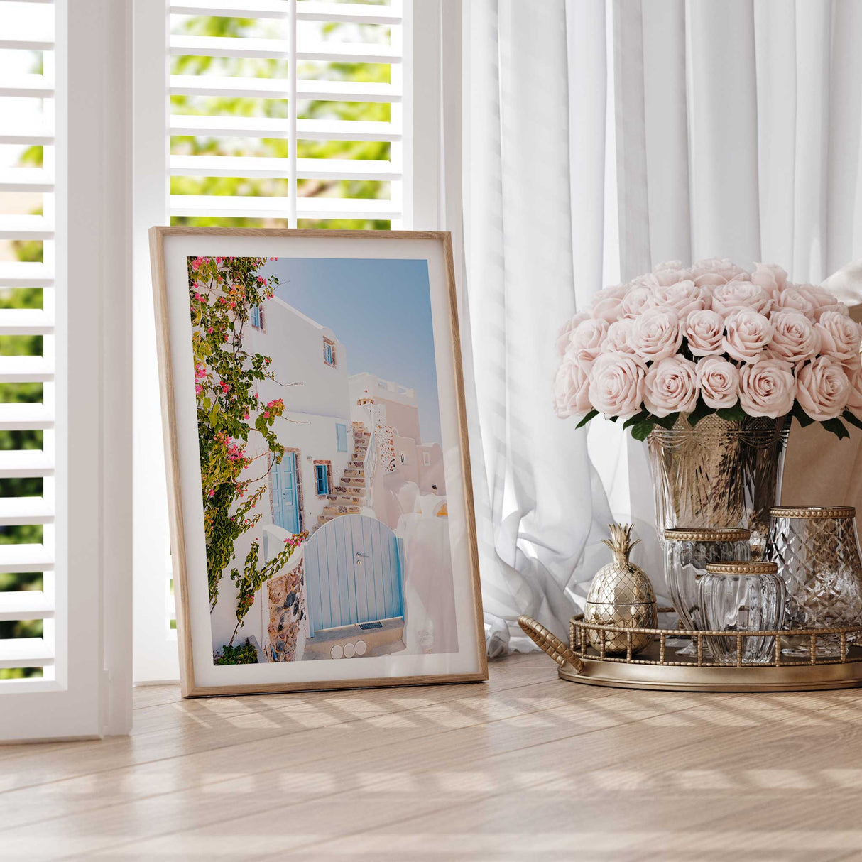 Santorini summer home with a bright blue gate, white architecture, and vibrant bougainvillea