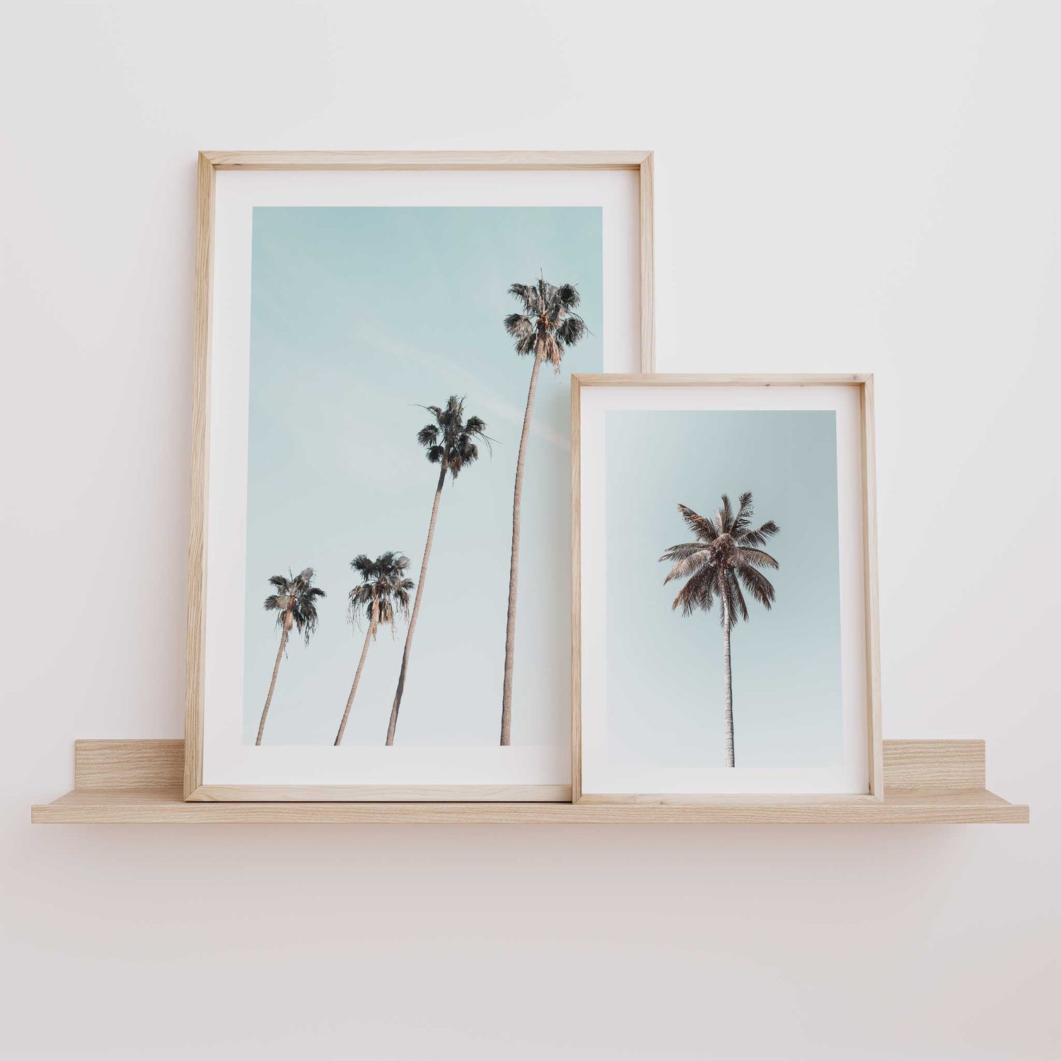Minimalist palm tree wall art with soft sky background
