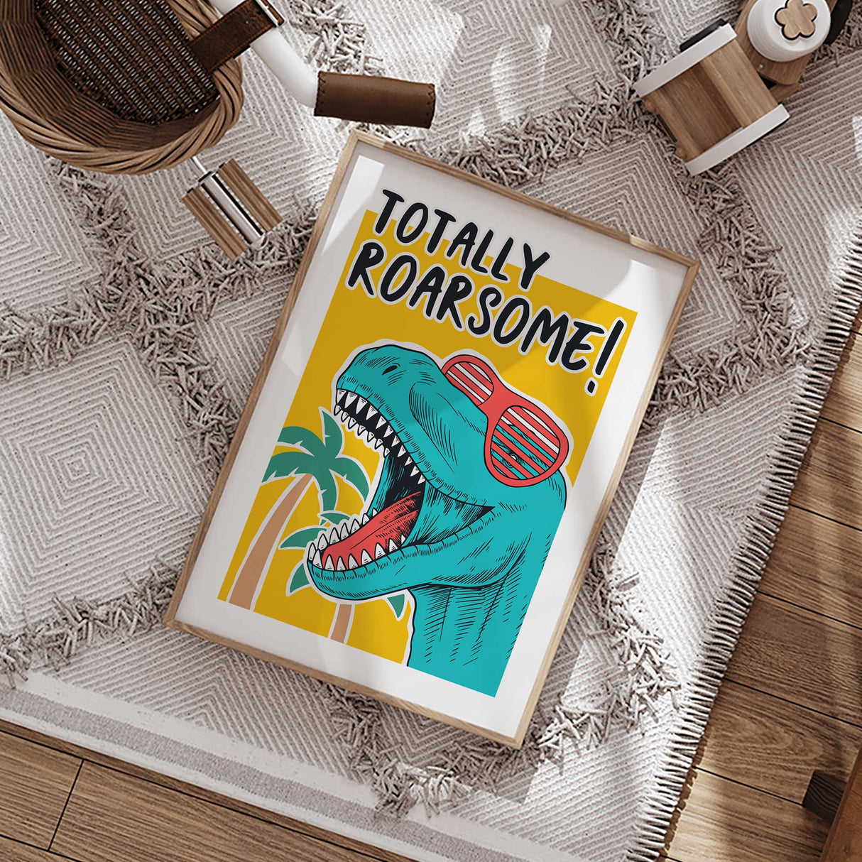 Colourful T-rex print with red shutter sunglasses, palm trees and bold black Totally Roarsome lettering.