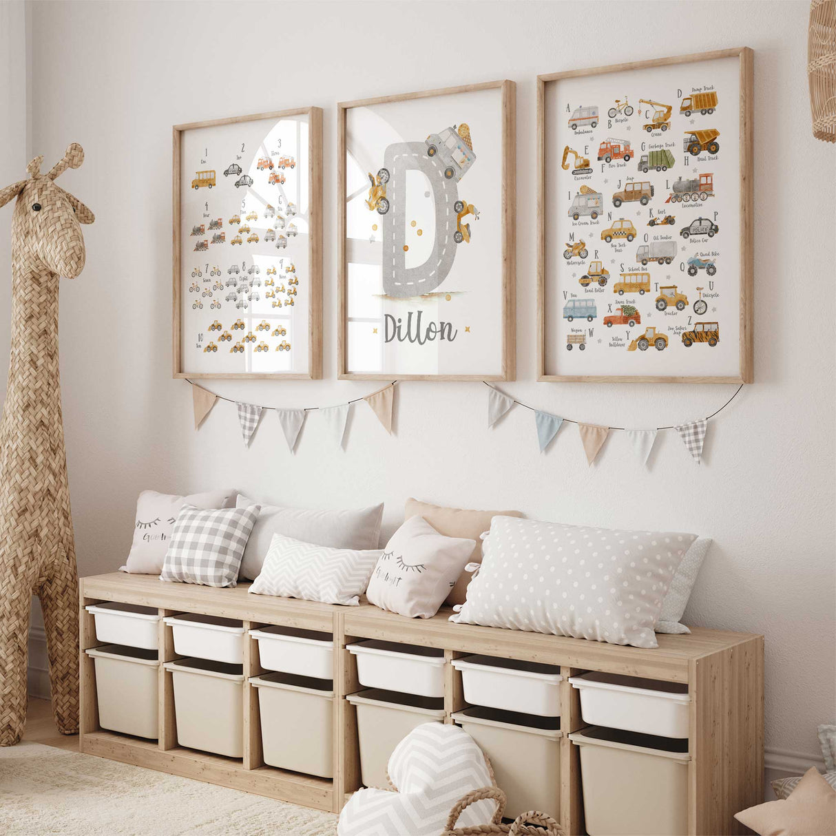 Three construction themed wall art prints displayed together in a warm neutral toddler bedroom