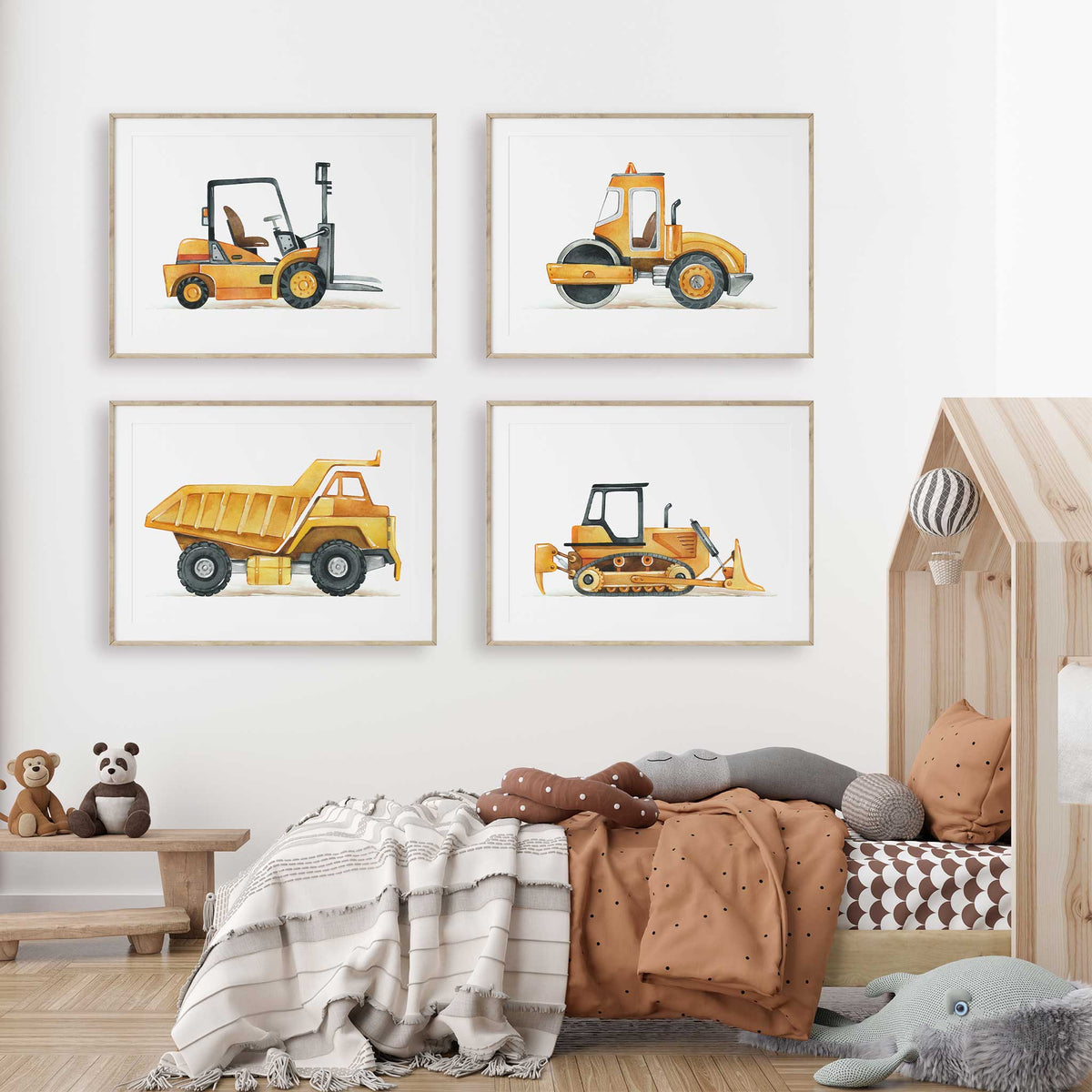 Four yellow watercolour construction vehicle prints showing a forklift, road roller, dump truck and bulldozer on white.