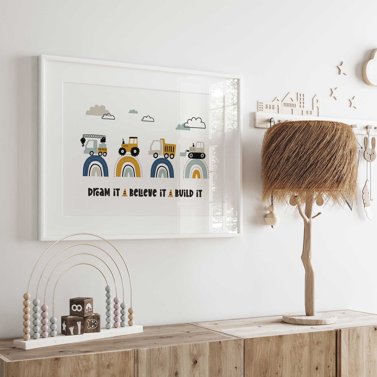 Construction quote print with crane, tractor, dump truck and bulldozer above rainbows and Dream It Believe It Build It.