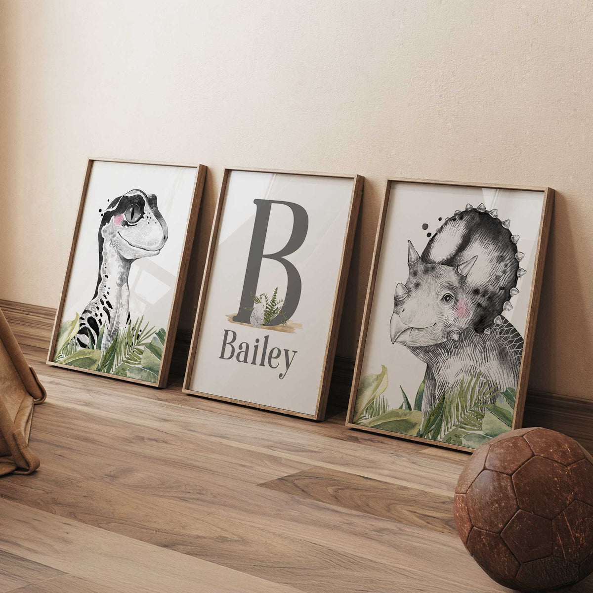 Dinosaur print set with black and white portraits, green leaves and a name and initial print.
