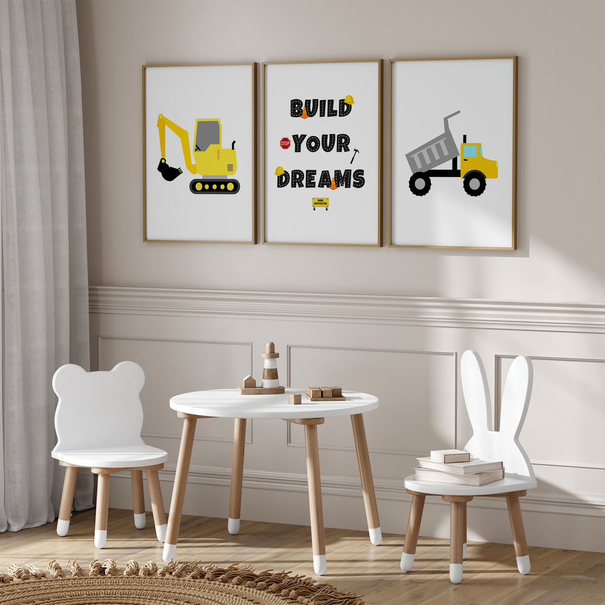 Yellow digger and dump truck prints with a Build Your Dreams quote, black road-style lettering and white backgrounds.
