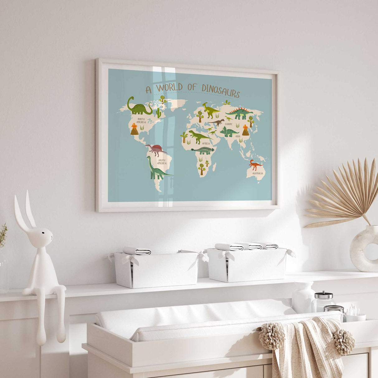 Dinosaur nursery wall art with a soft blue world map, green dinosaurs and labelled continents.