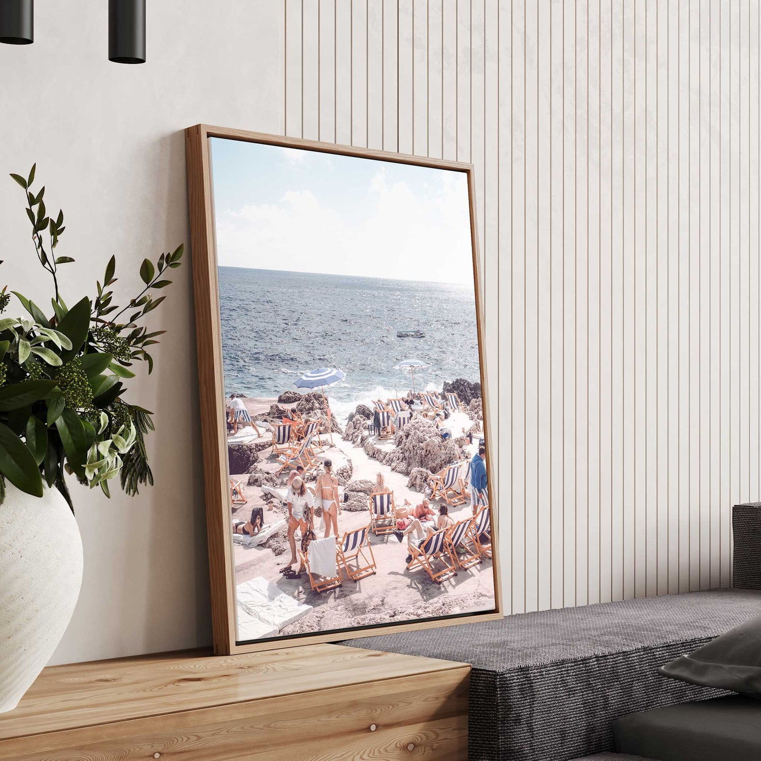 Summer beach club vibes on rocky coast with umbrellas and ocean backdrop