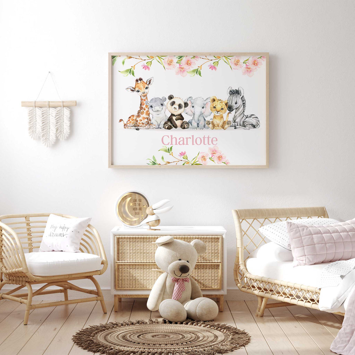 Girls nursery wall art with six baby safari animals and custom name shown with pink blossoms for personalised bedroom decor
