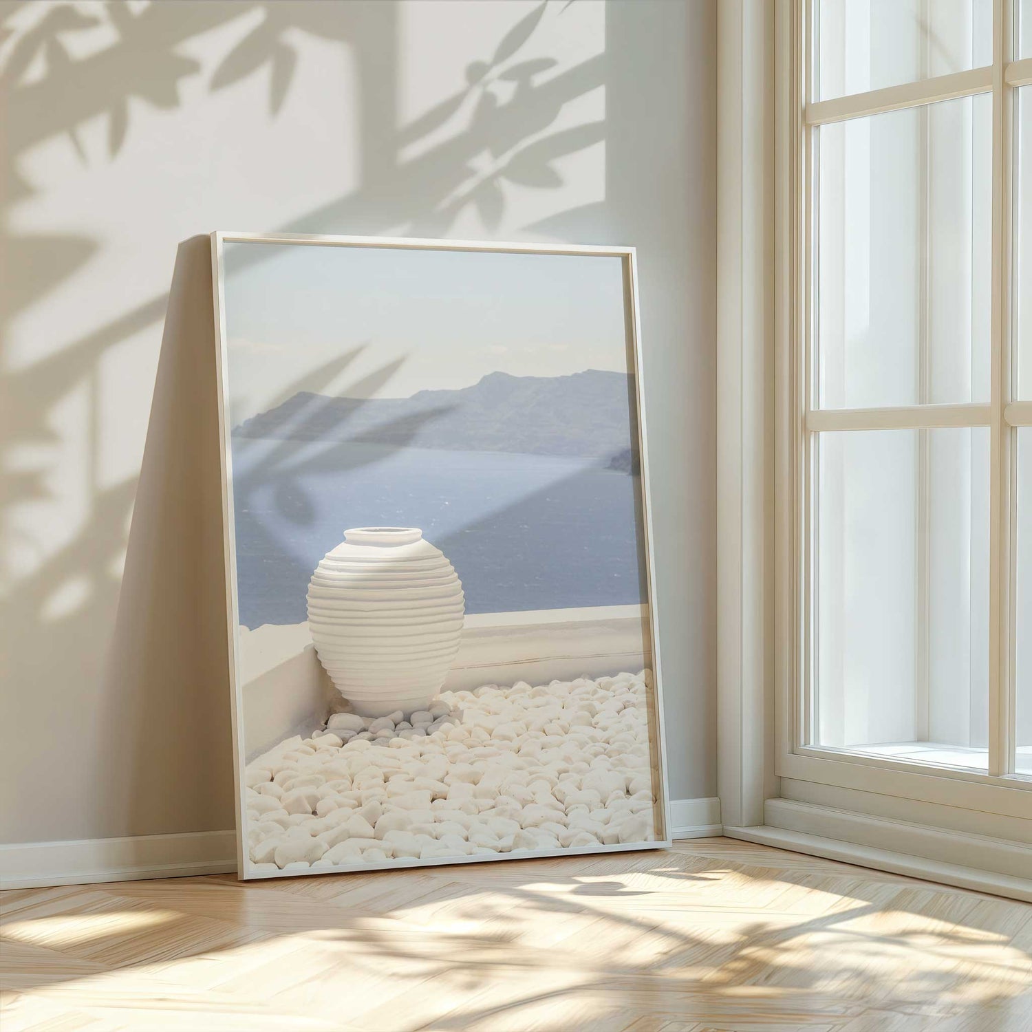 Framed view of the Aegean Sea with sculptural vase and coastal light