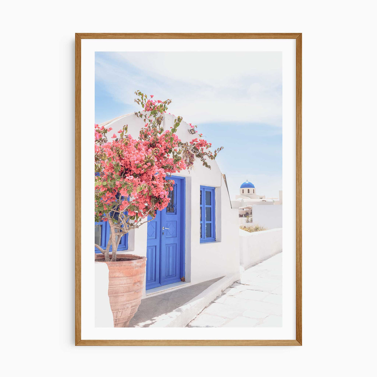 Greek island photography print featuring blue door and pink flowers