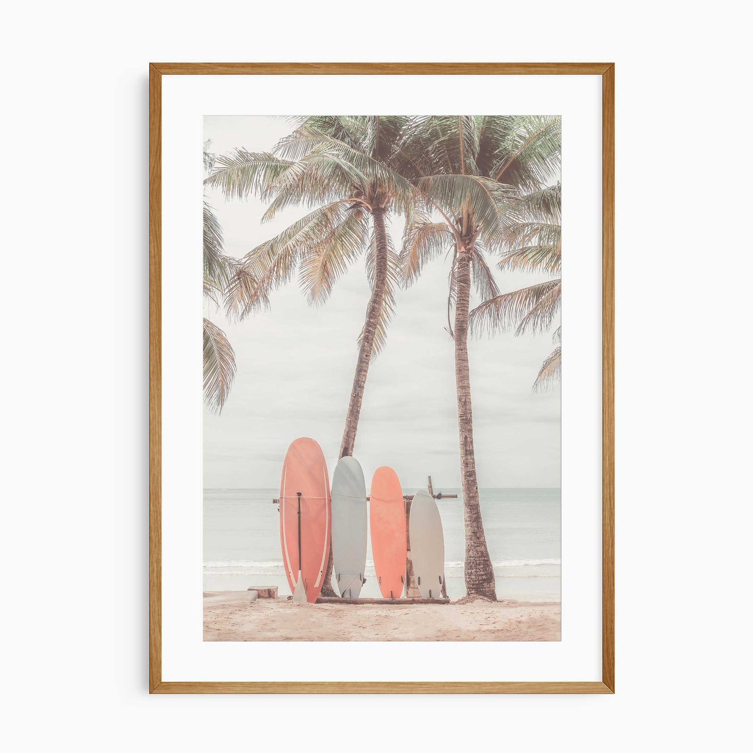 Surfboards leaning against palm trees on tropical beach