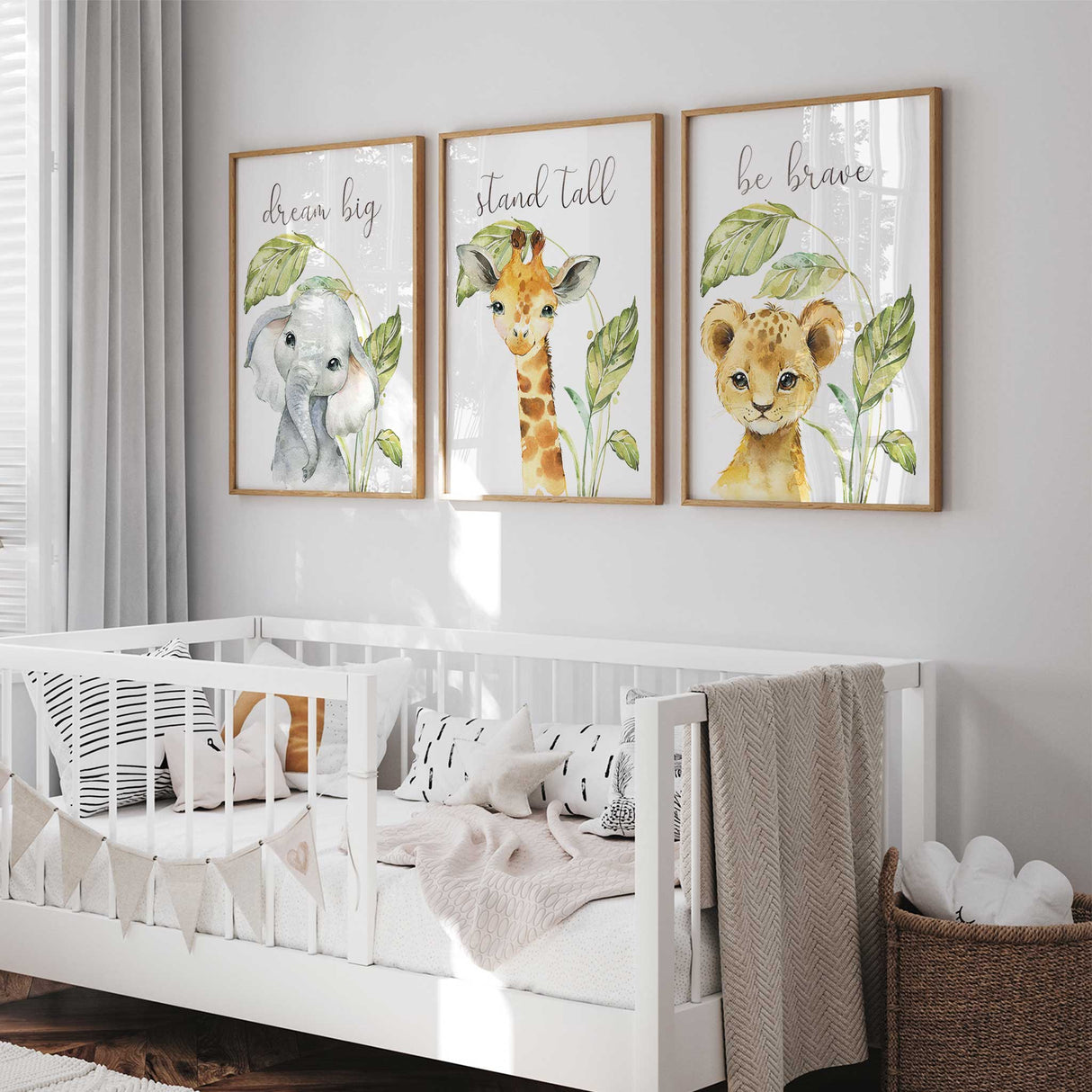 Stylish nursery decor inspiration showcasing safari animal prints with uplifting quotes framed on nursery wall.