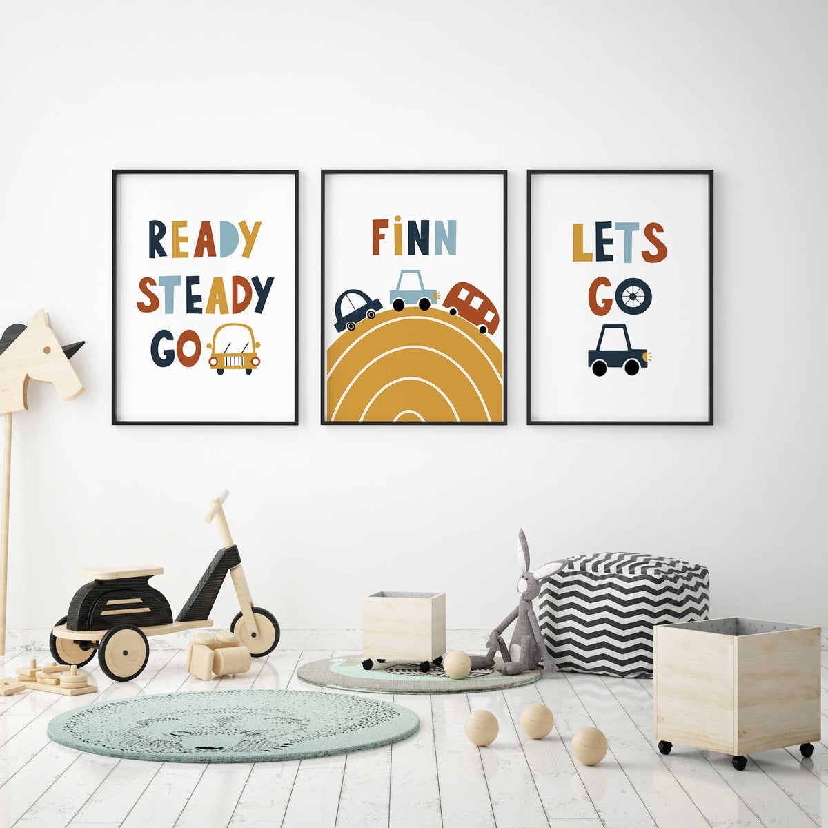 Car wall art set with personalised name on a mustard road print, flanked by Ready Steady Go and Let's Go designs with cars.
