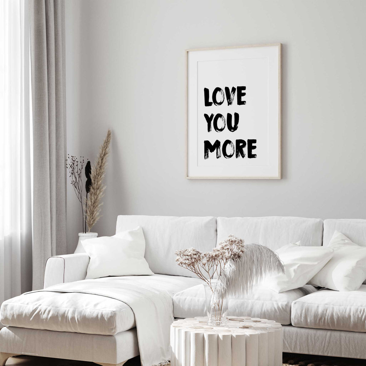 Love you more typography wall art with black brush lettering on a white background