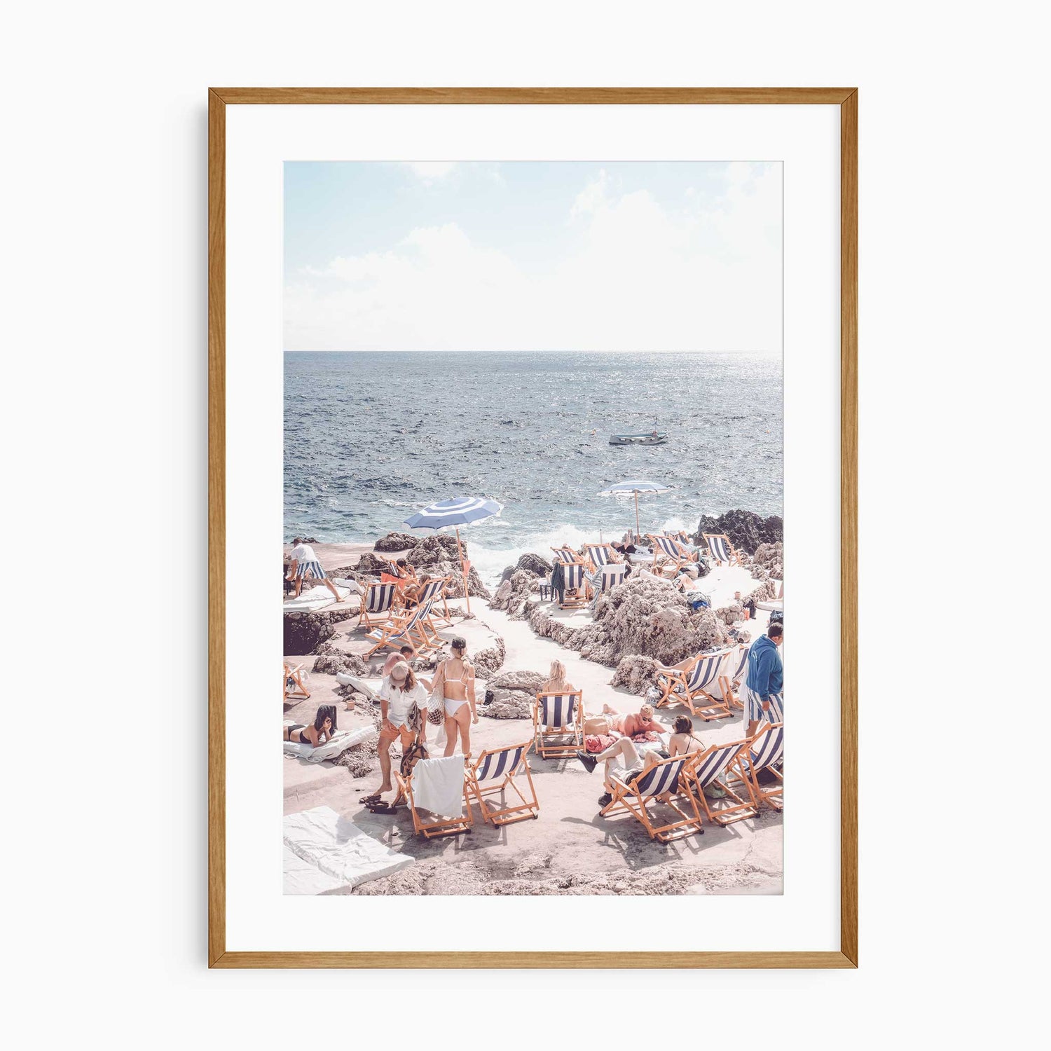 Coastal beach wall art with striped loungers on rocky Mediterranean shore