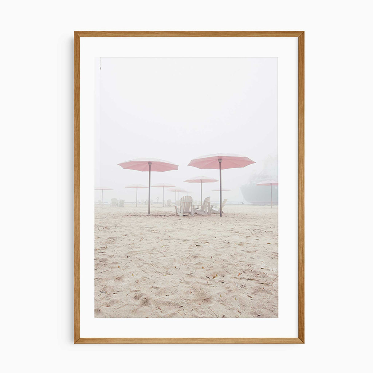 Minimalist beach wall art featuring pink umbrellas and wooden chairs on soft sand