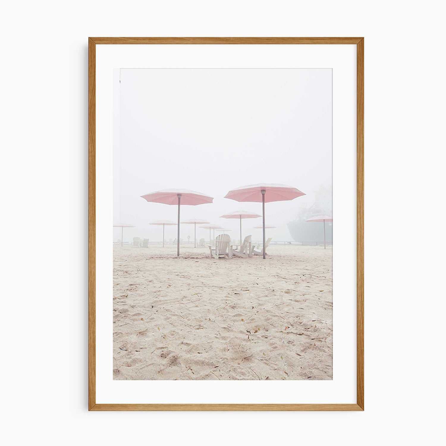 Minimalist beach wall art featuring pink umbrellas and wooden chairs on soft sand