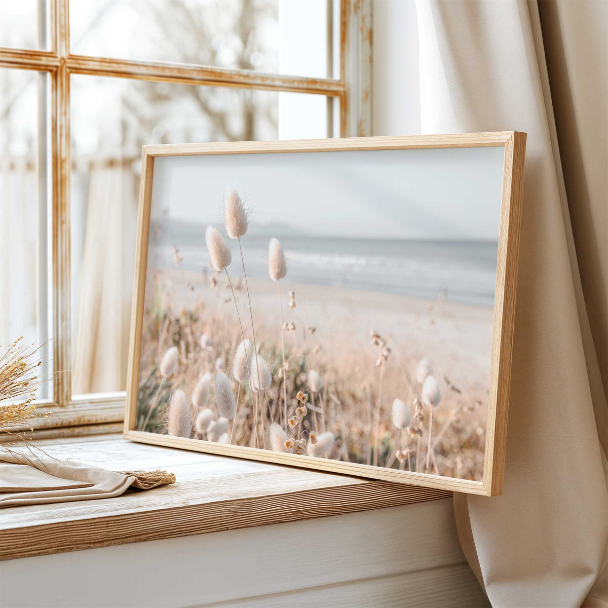 Neutral coastal beach wall art featuring pale grasses and a soft shoreline in natural cream and blue tones