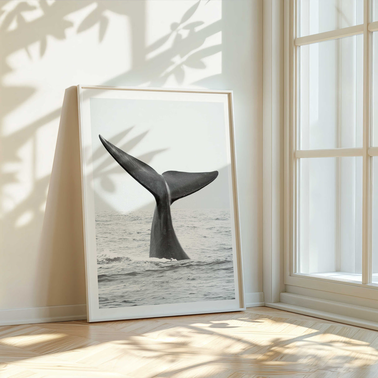 neutral ocean photography print featuring whale tail emerging from the ocean