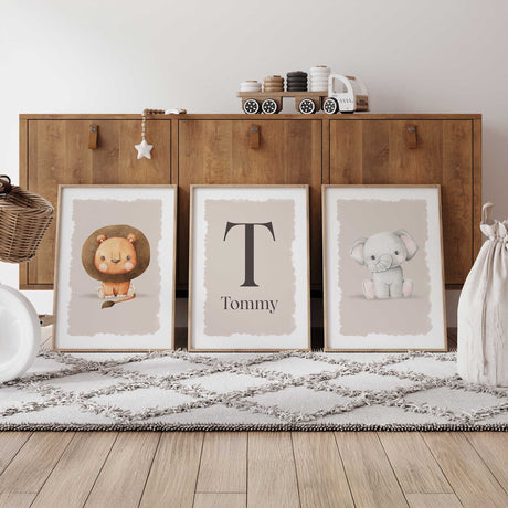Neutral-toned nursery print set with lion, elephant, and personalised name print for baby room decor.