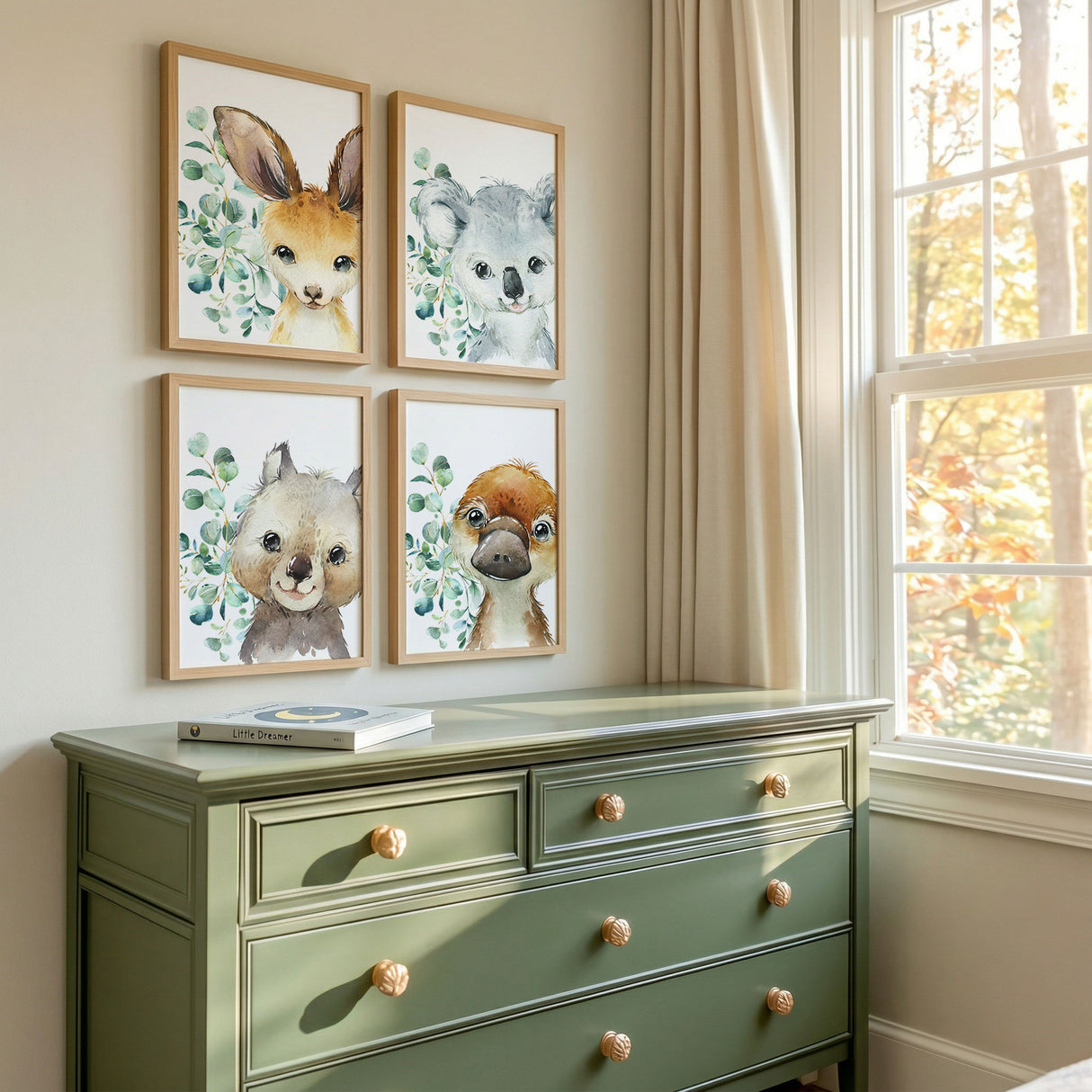 Set of four Australian animal nursery wall art prints featuring a kangaroo koala wombat and platypus with eucalyptus leaves.