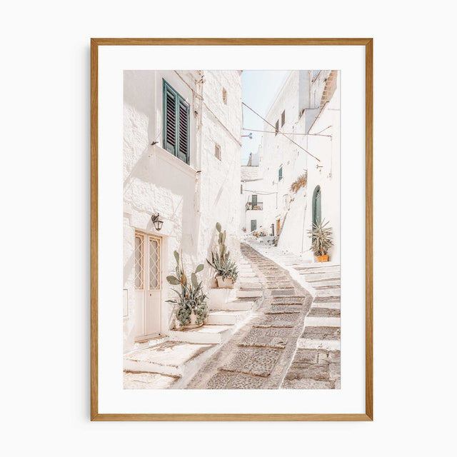 Wall art print of Ostuni alleyway in Apulia, Italy with whitewashed buildings and stone steps.