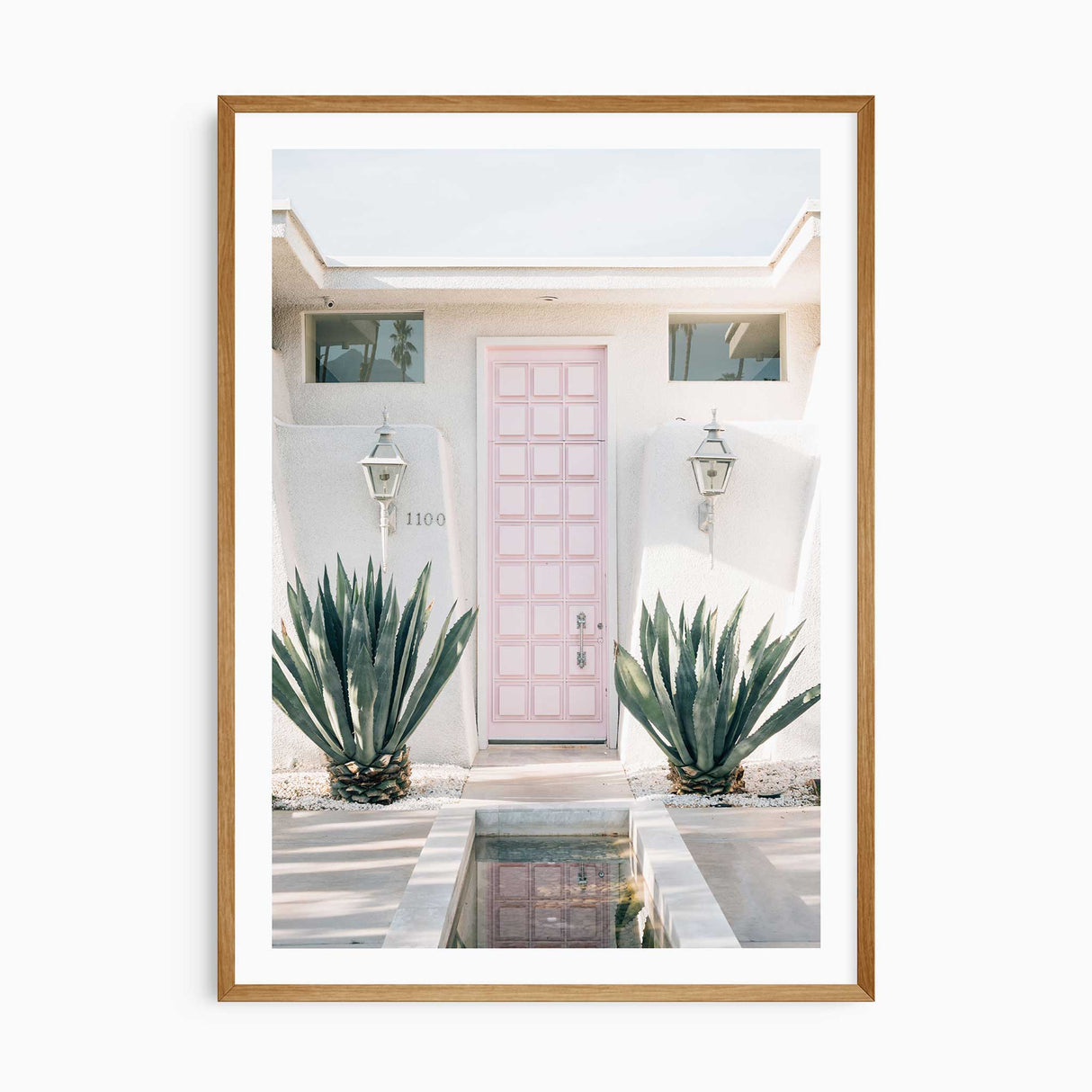 Palm Springs pink door wall art print with white border, mid-century modern home decor photography.
