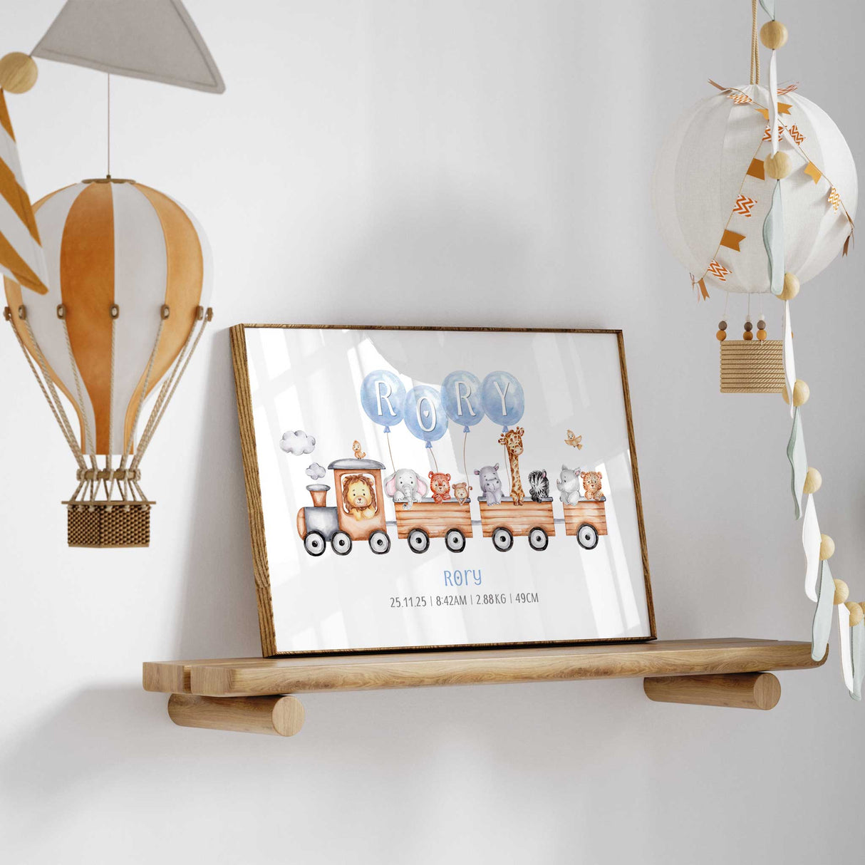 Personalised nursery print featuring a wooden train with cute safari animals, blue name balloons spelling babys name and custom birth details underneath.