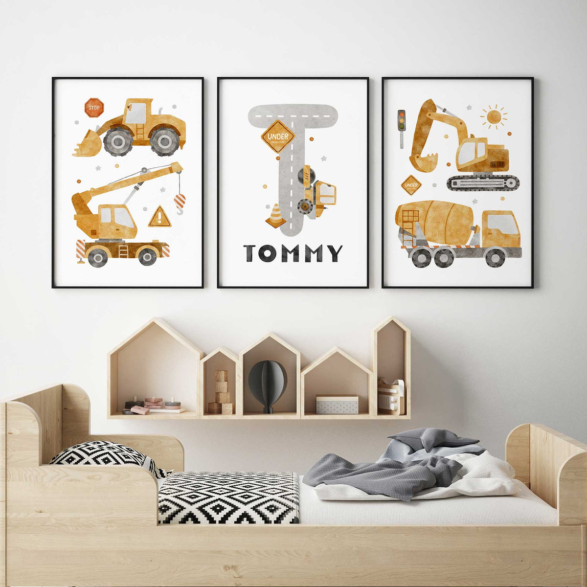 Three yellow construction vehicle prints with a grey road-shaped initial and the Childs name on the personalised centre print.