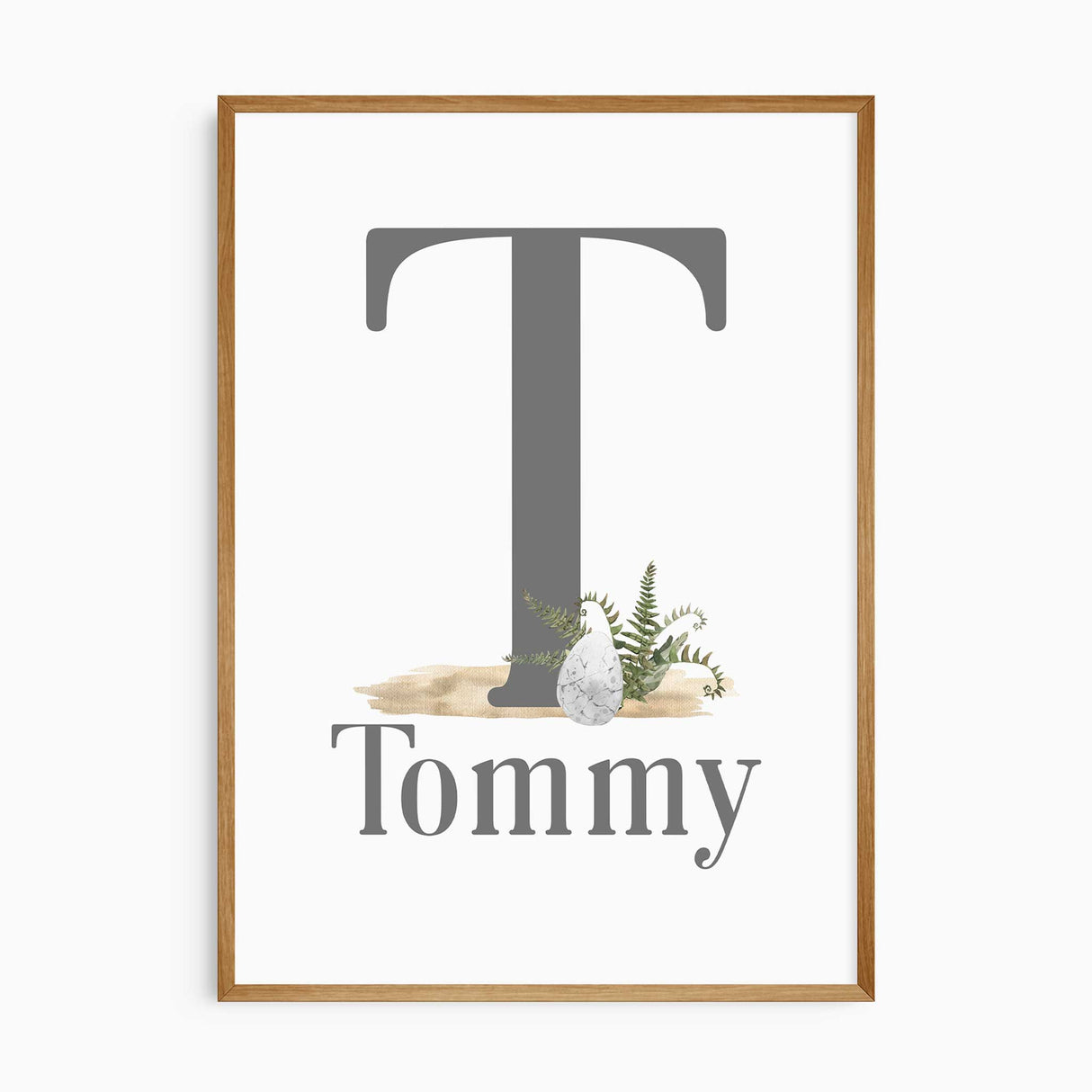 Personalised dinosaur nursery wall art with custom name and initial, featuring jungle leaves and neutral tones for boys bedroom decor