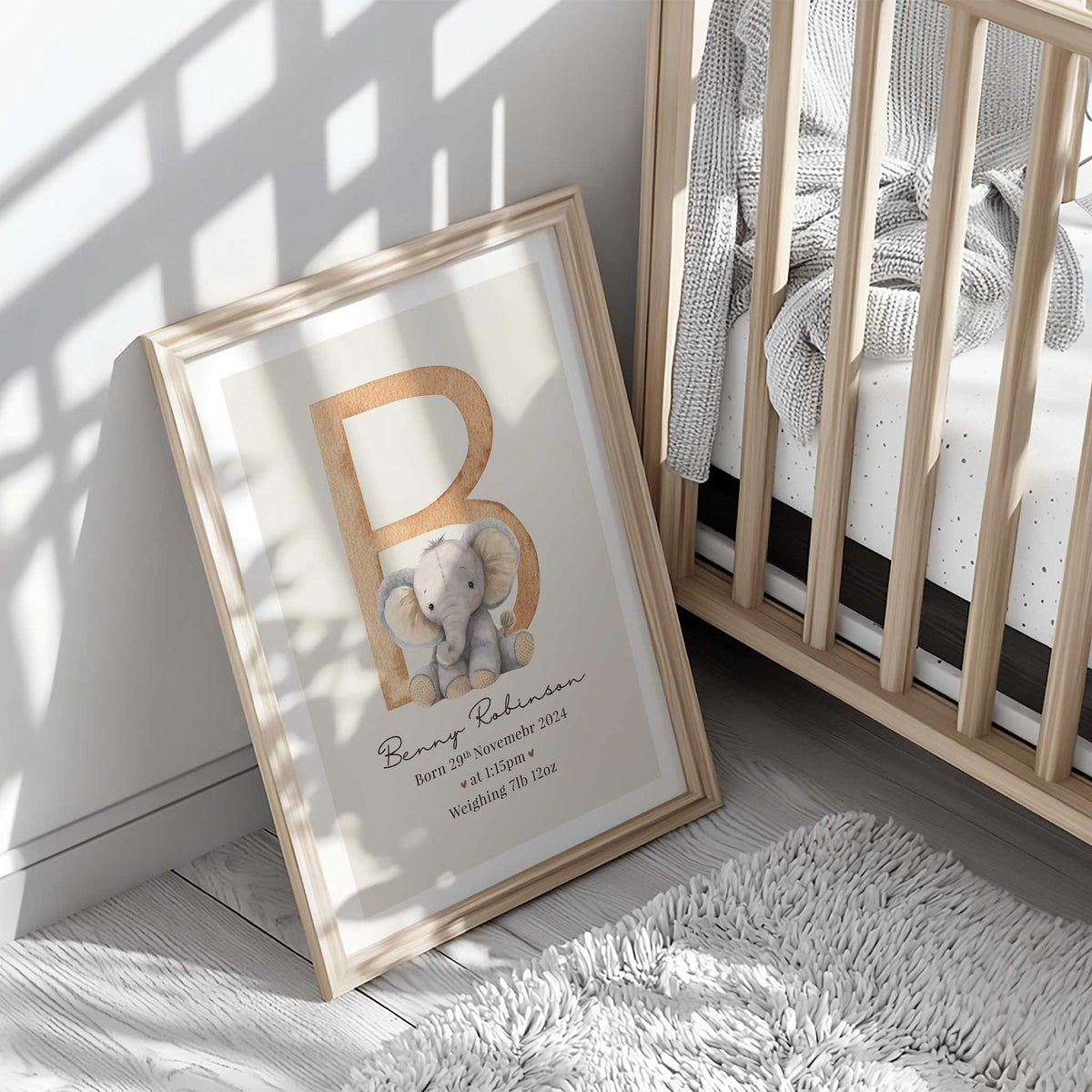 Personalised elephant birth print with a large initial, baby’s name, birth date, time and weight on a neutral background