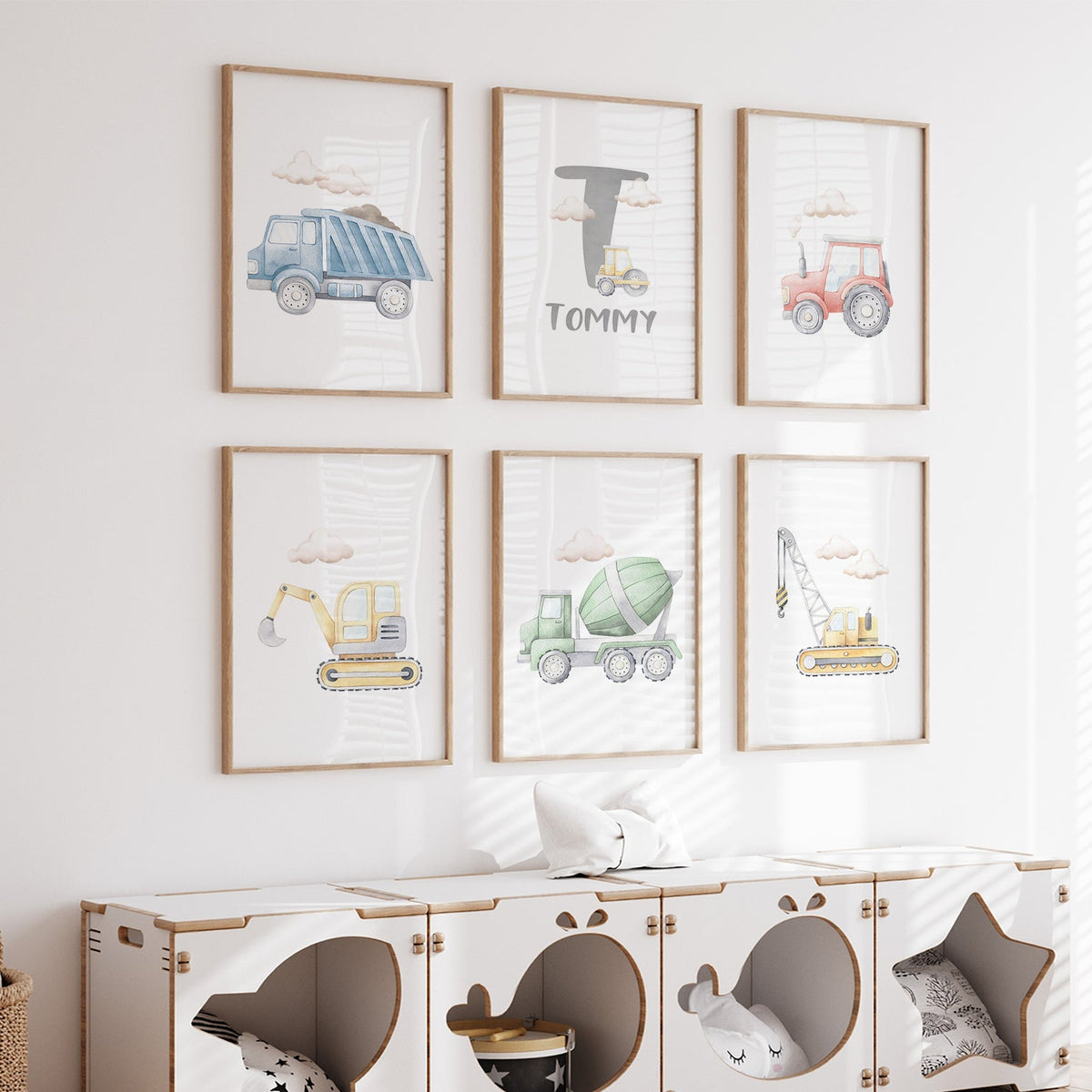 Set of six watercolour construction prints with multicolour vehicles, clouds and a grey initial above the name.