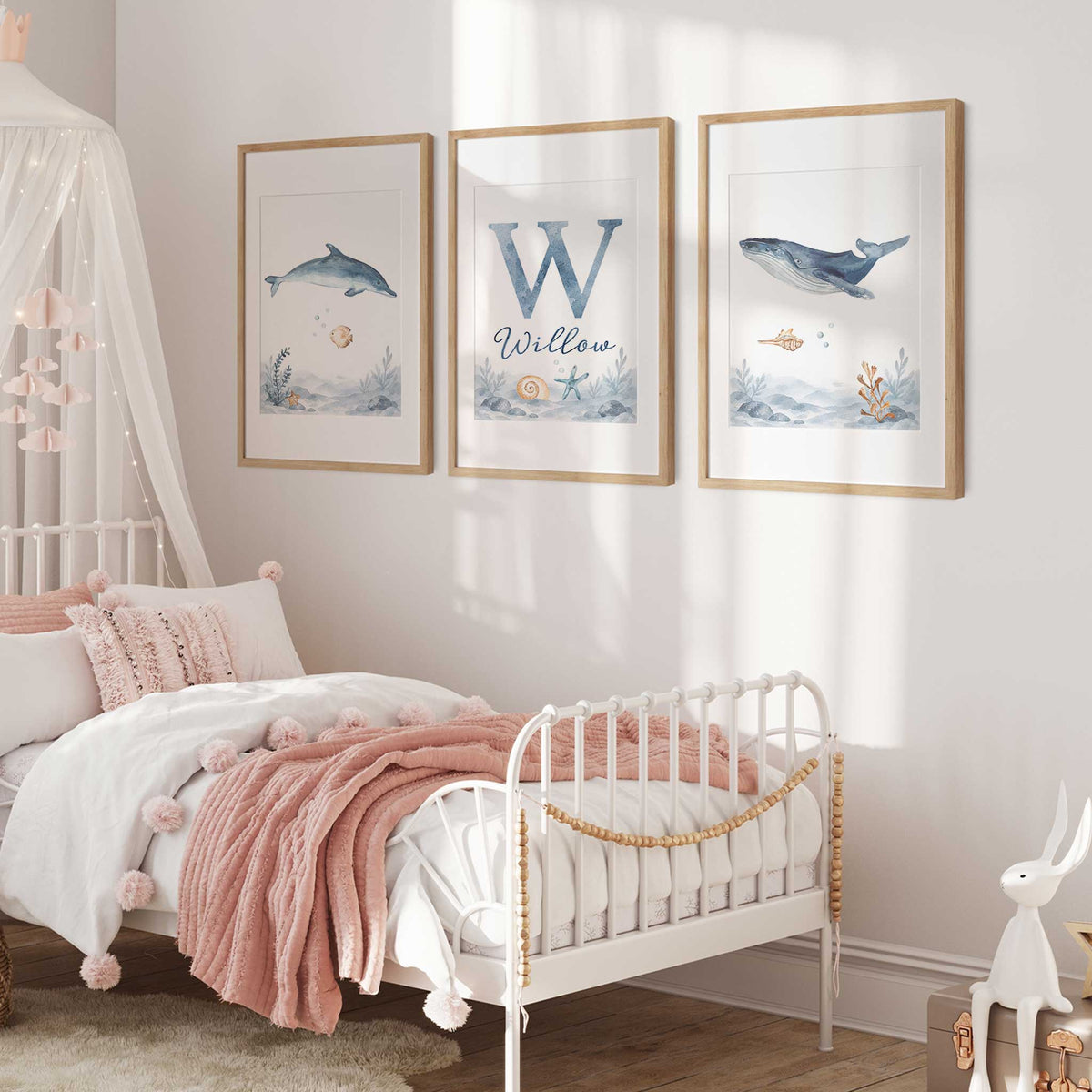 Set of three personalised ocean prints featuring a watercolour dolphin, whale and initial name design with shells and starfish.