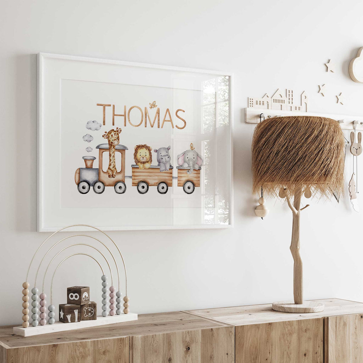 Personalised nursery print with name above a wooden-style train carrying four safari animals, with clouds and small birds.