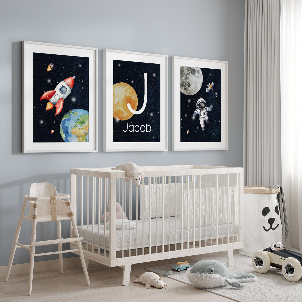 Personalised space nursery wall art set with rocket, astronaut and custom initial name print in deep navy tones for boys bedroom decor