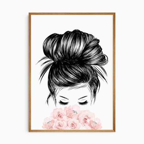 A framed print of a black and white illustration of a woman's head with her hair in a bun, eyes closed, and her face partially obscured by pink flowers.