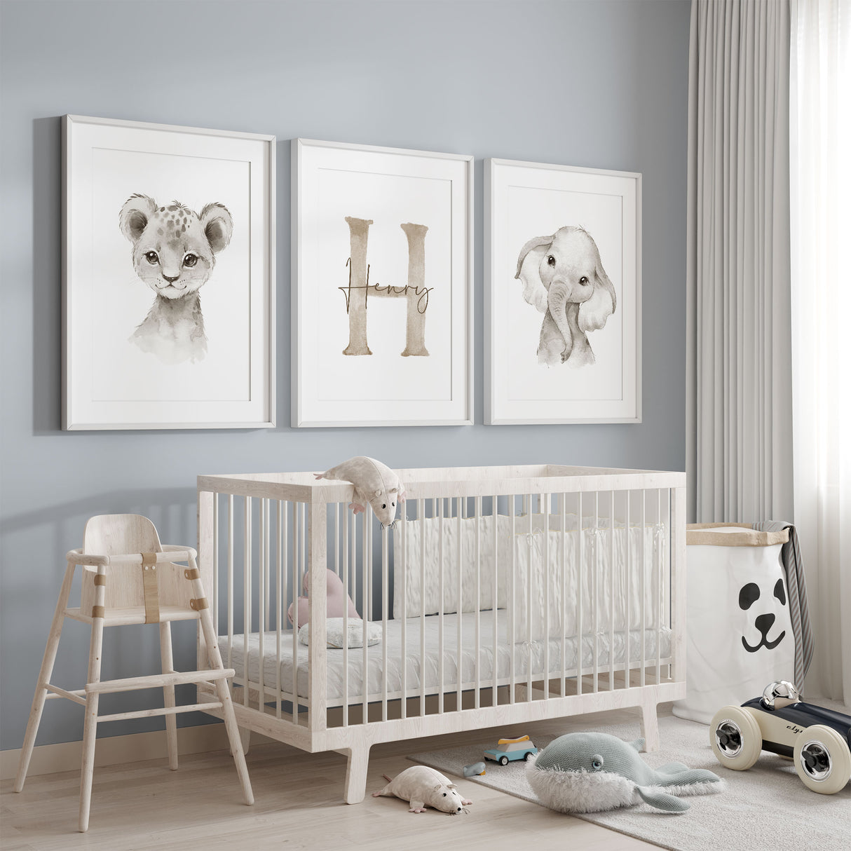Safari nursery wall art set of three featuring a baby lion cub, baby elephant and personalised initial print in soft neutral tones