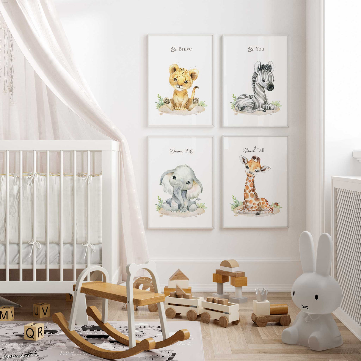 A set of four safari jungle animal prints featuring a lion, elephant, zebra, and giraffe, displayed on a nursery room wall above a wooden crib with toys.