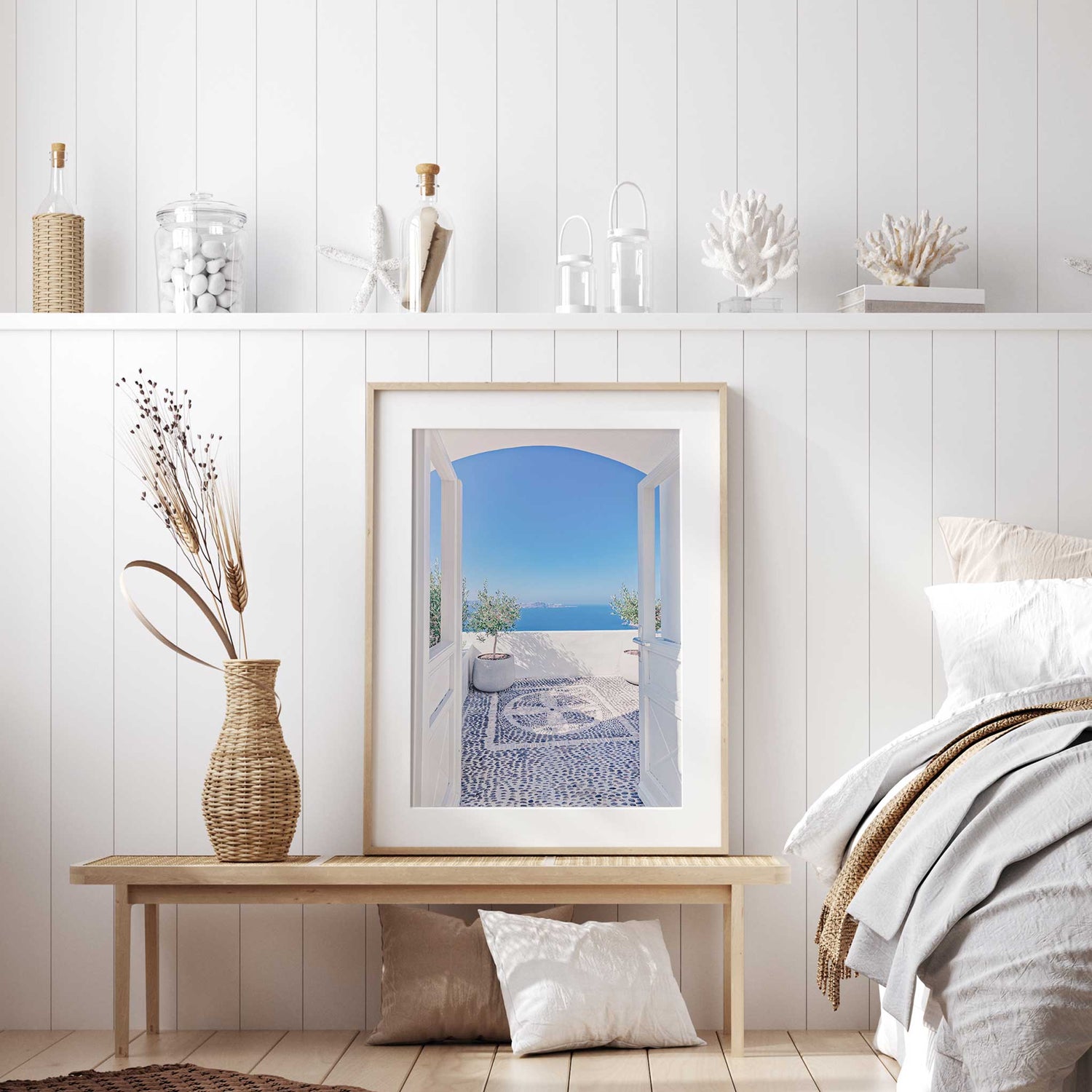 A picturesque white-washed patio with an arched doorway, mosaic flooring, and a calming Mediterranean sea view.