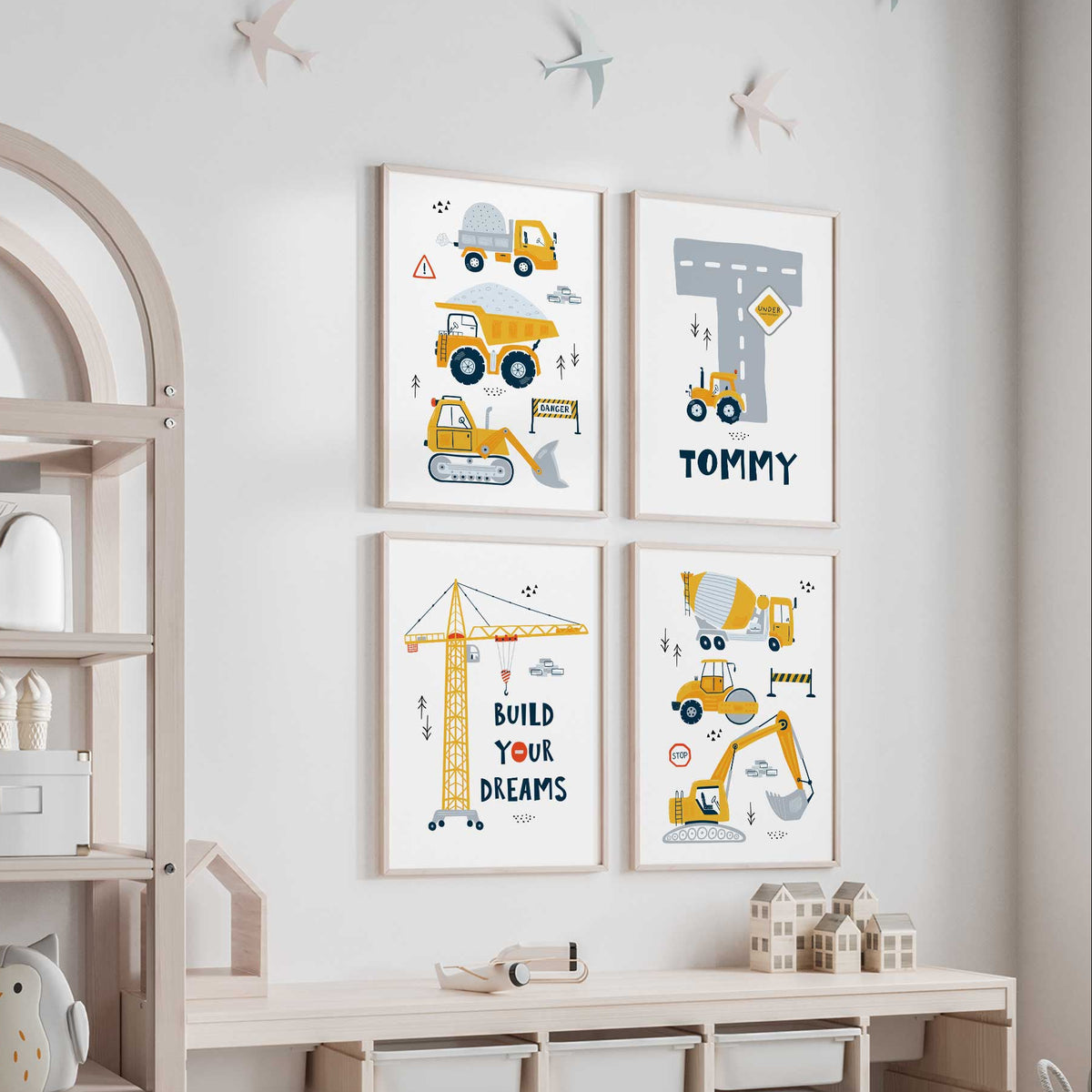 Four yellow construction prints with trucks, diggers, a Build Your Dreams crane and personalised road initial on white.