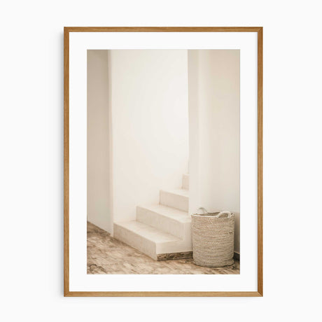 Soft-toned neutral wall print of staircase and woven basket
